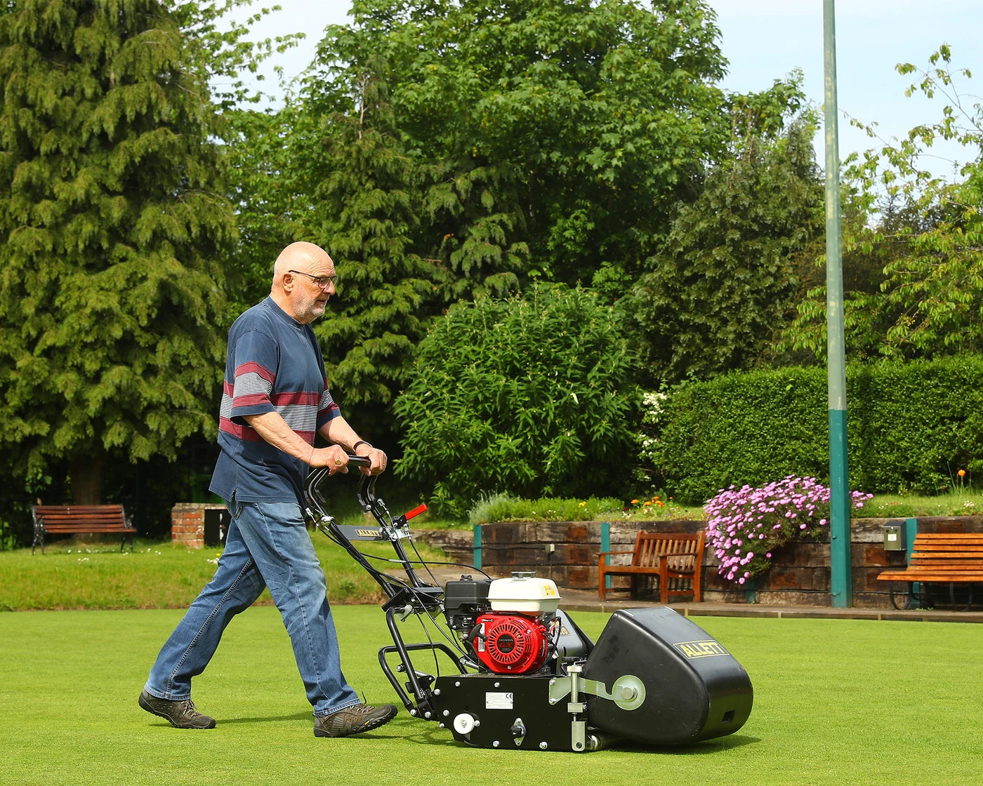 Allett C20 petrol cylinder mower on a detailed park lawn