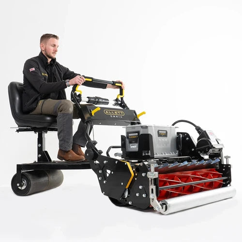 Man Operating Omnia 34 with Trailing Seat attached with plain white background